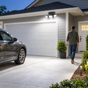 Solar motion light brightly illuminating a garage driveway approach
