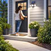 Woman arriving home at a brightly lit front entry with a solar motion light