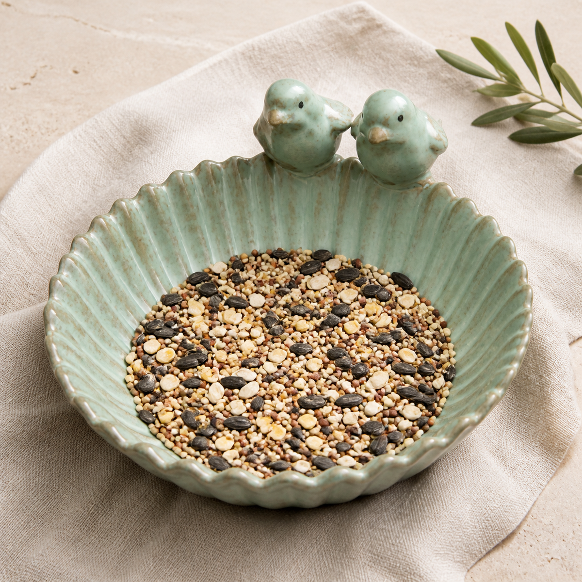 Top view of scalloped ceramic bird feeder filled with mixed birdseed