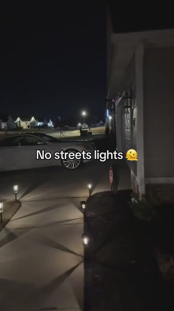 Solar motion light illuminating a driveway after dark